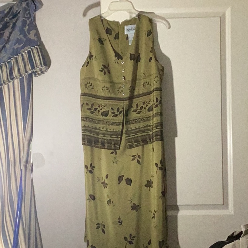 Olive Green with off black leaves and silver buttons and tie in the back.